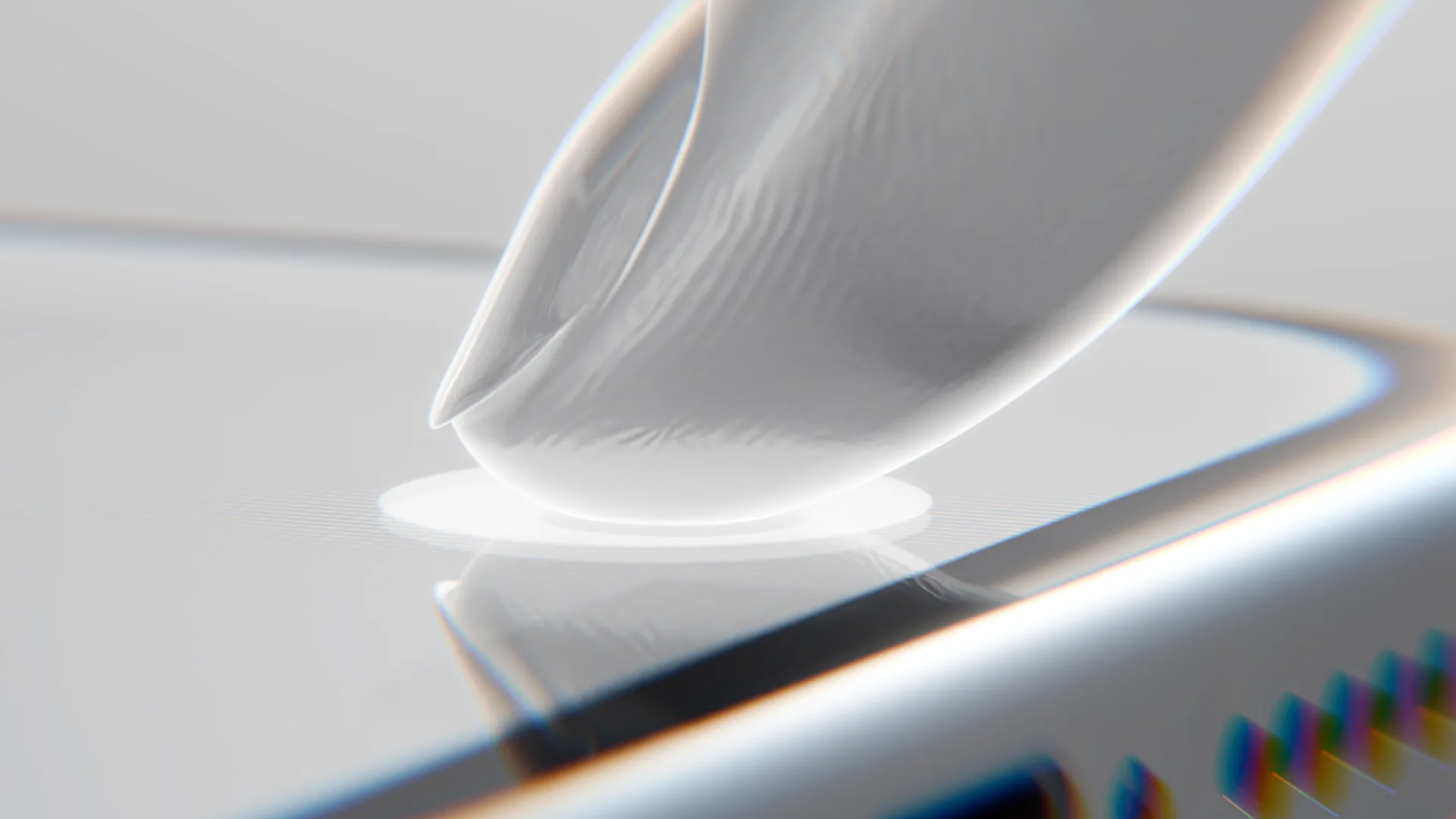 A fingertip touching a glass screen