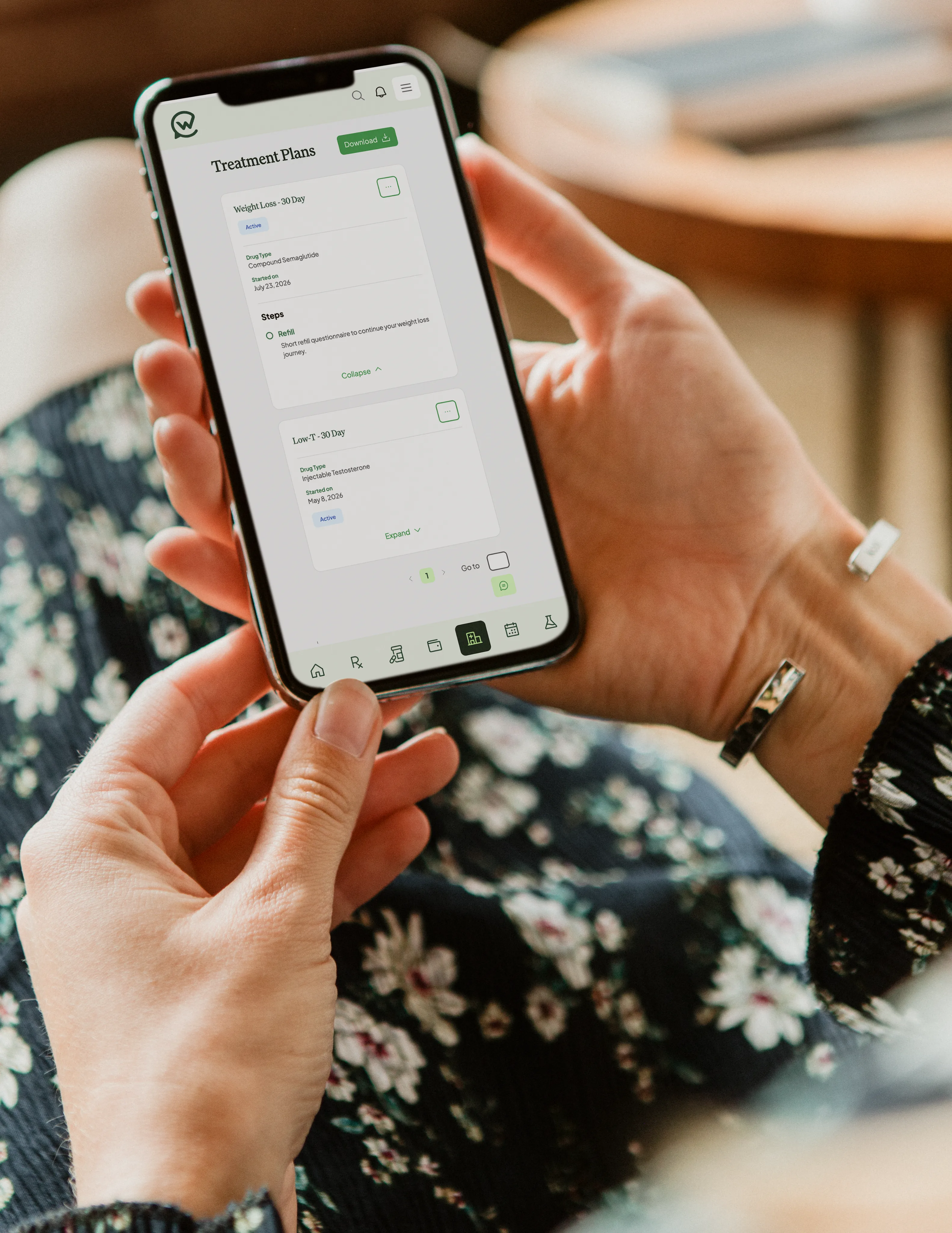 Hands holding a phone open to a patient portal