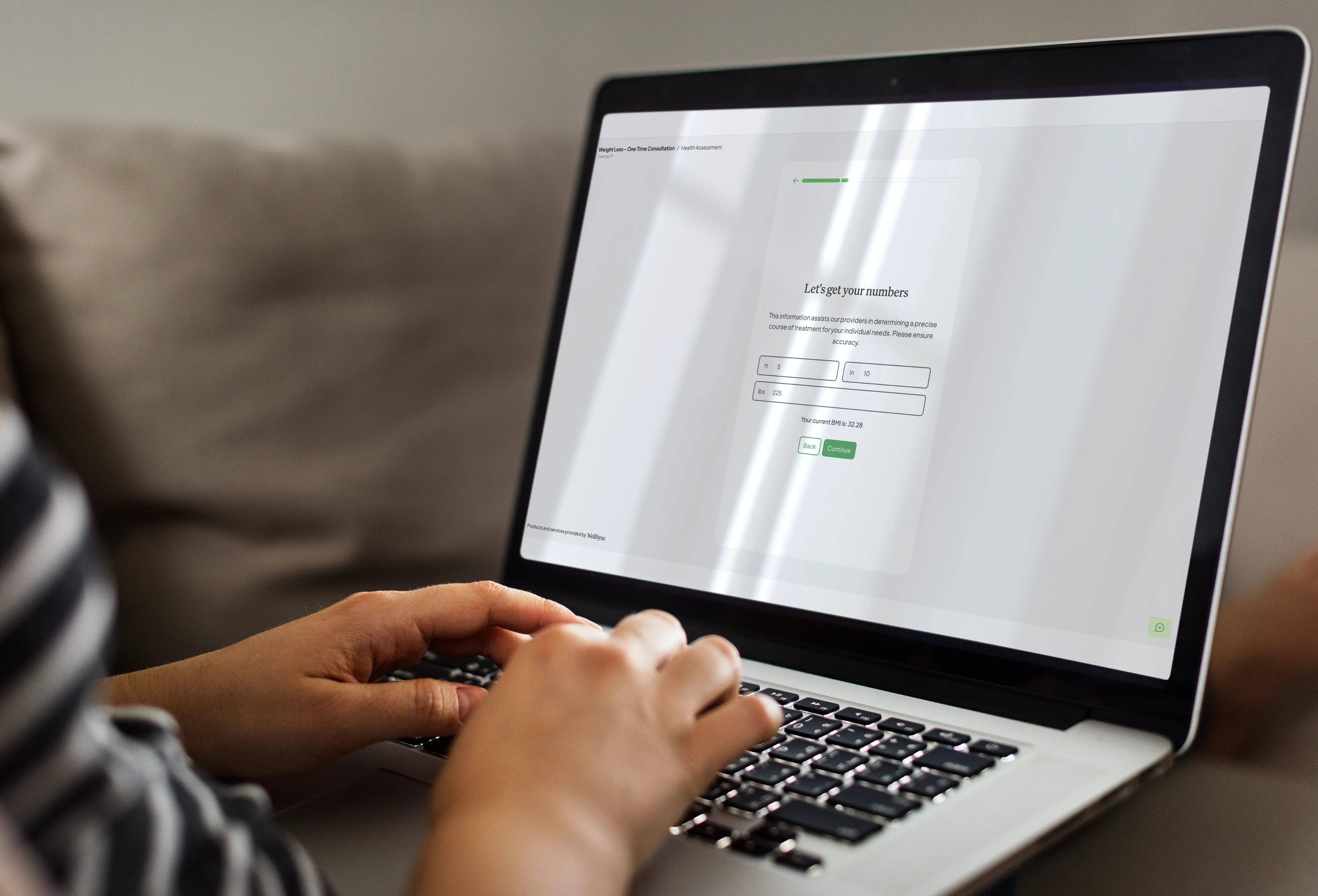 Hands typing on a laptop showing an intake form