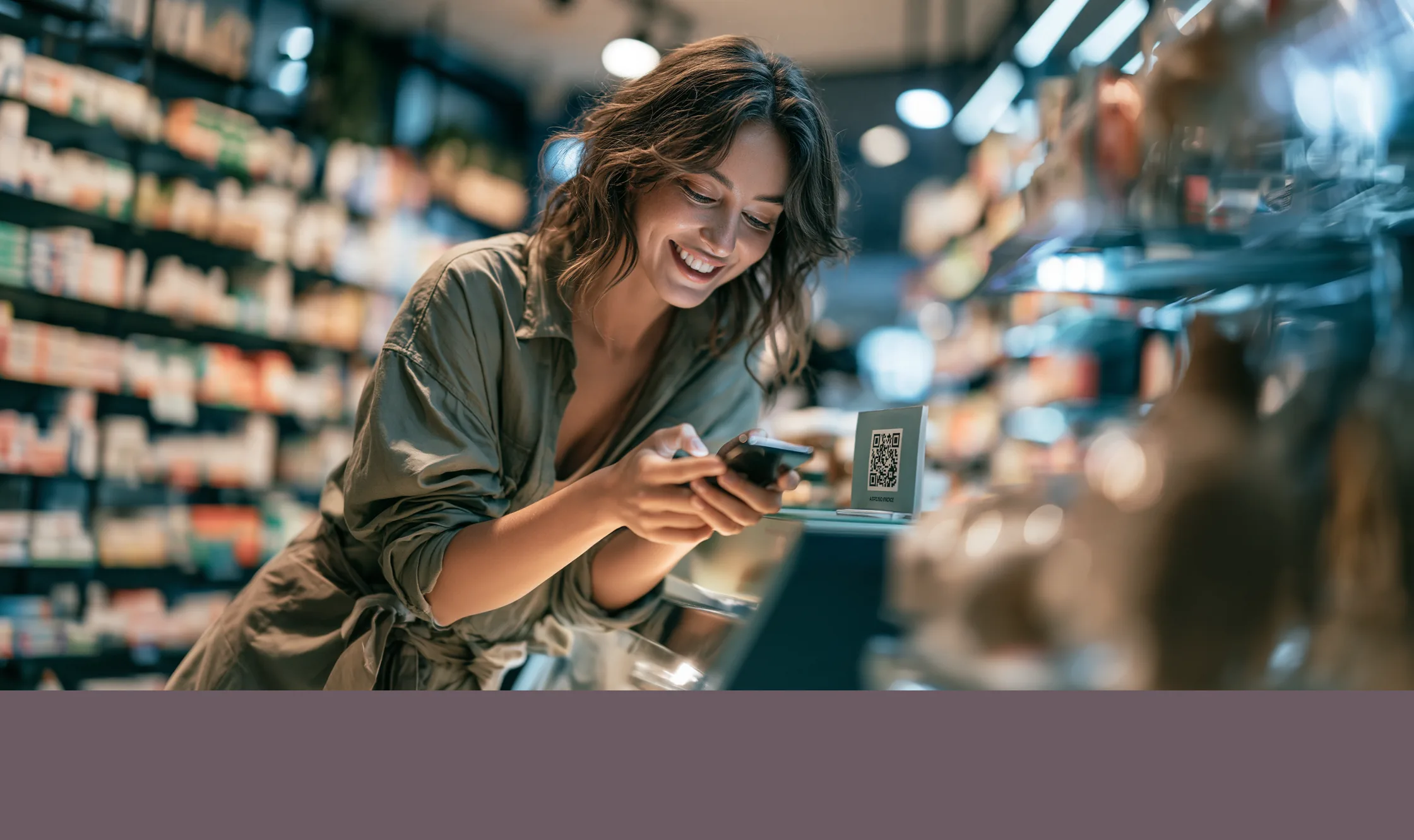 A shopper in a pharmacy aisle scanning a QR code with her phone