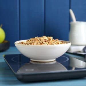 A bowl of grains on a kitchen scale
